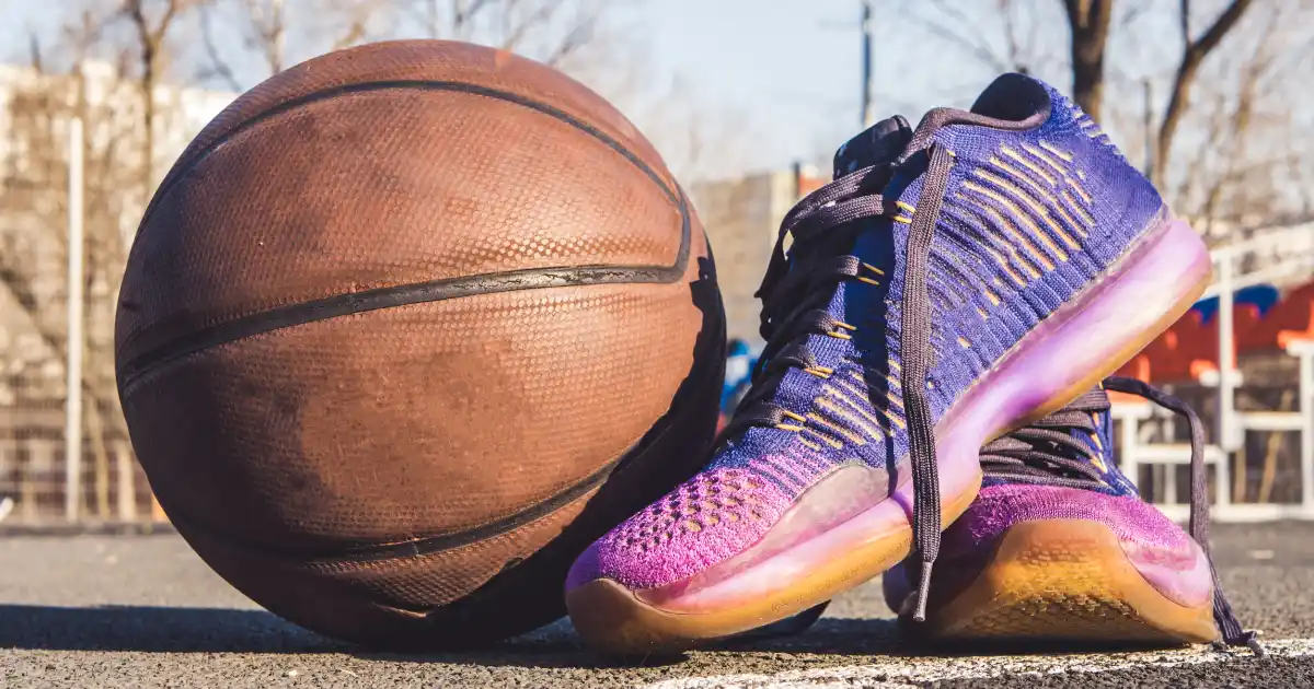 Basketball shoes beside a ball on an outdoor court — best basketball shoes for plantar fasciitis, Podiatrist Tested