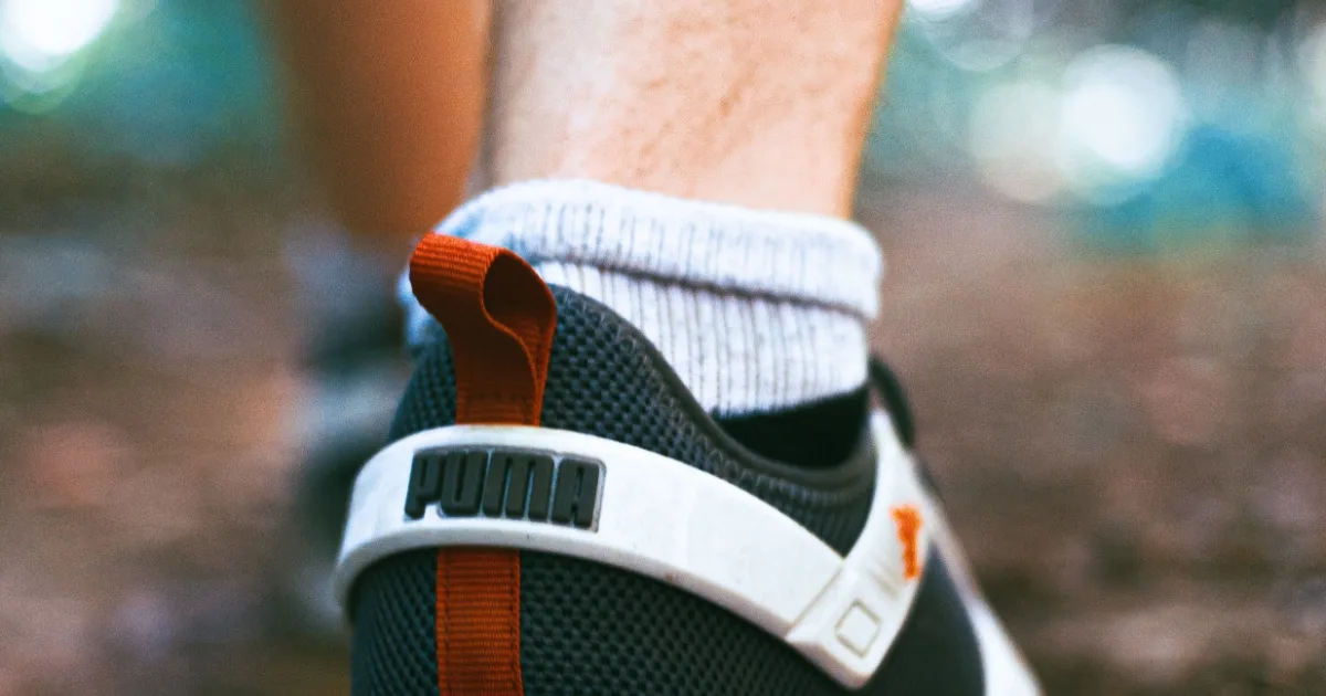 A walking shoe mid-stride on a woodland path — best HOKA shoes for walking, Podiatrist Tested