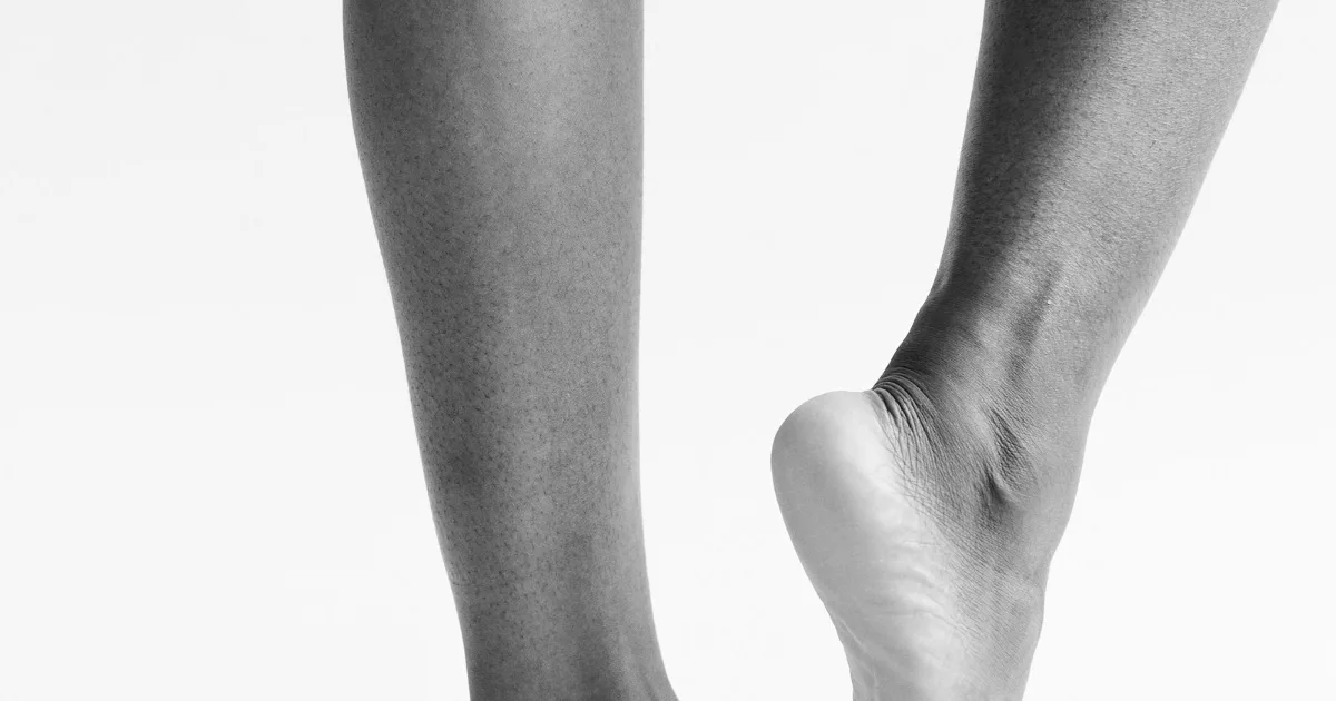 Monochrome study of lower legs, one heel raised — best shoes for Achilles tendonitis, Podiatrist Tested