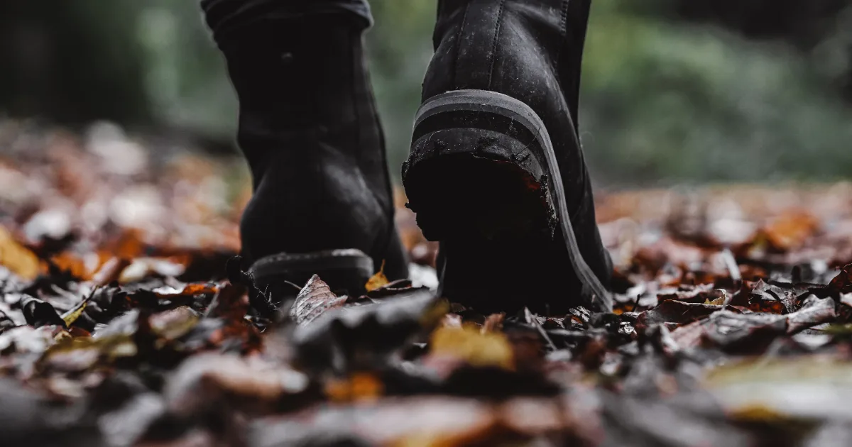 Boots walking on a leaf-covered path — best shoes for arthritis in the feet, Podiatrist Tested