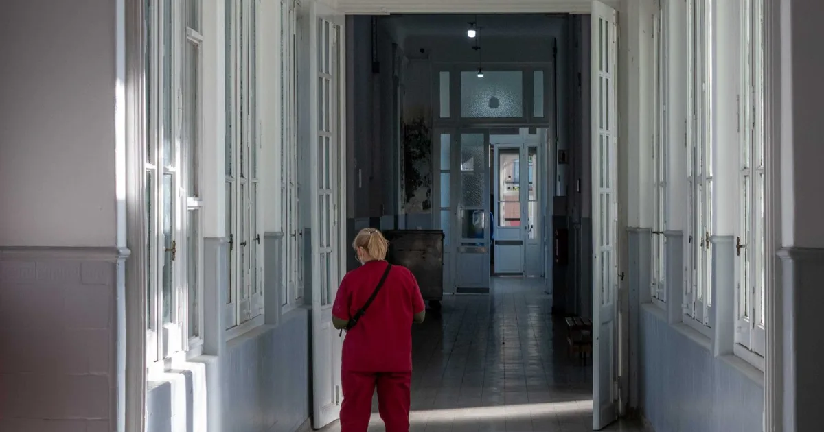 Long hospital corridor with a lone figure at the far end — best shoes for standing all day, Podiatrist Tested