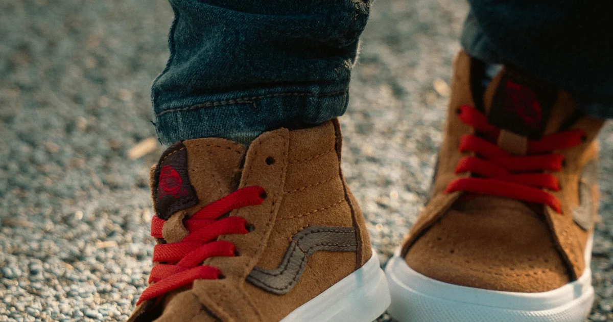 A toddler standing in sneakers on pavement - best shoes for toddlers, Podiatrist Tested