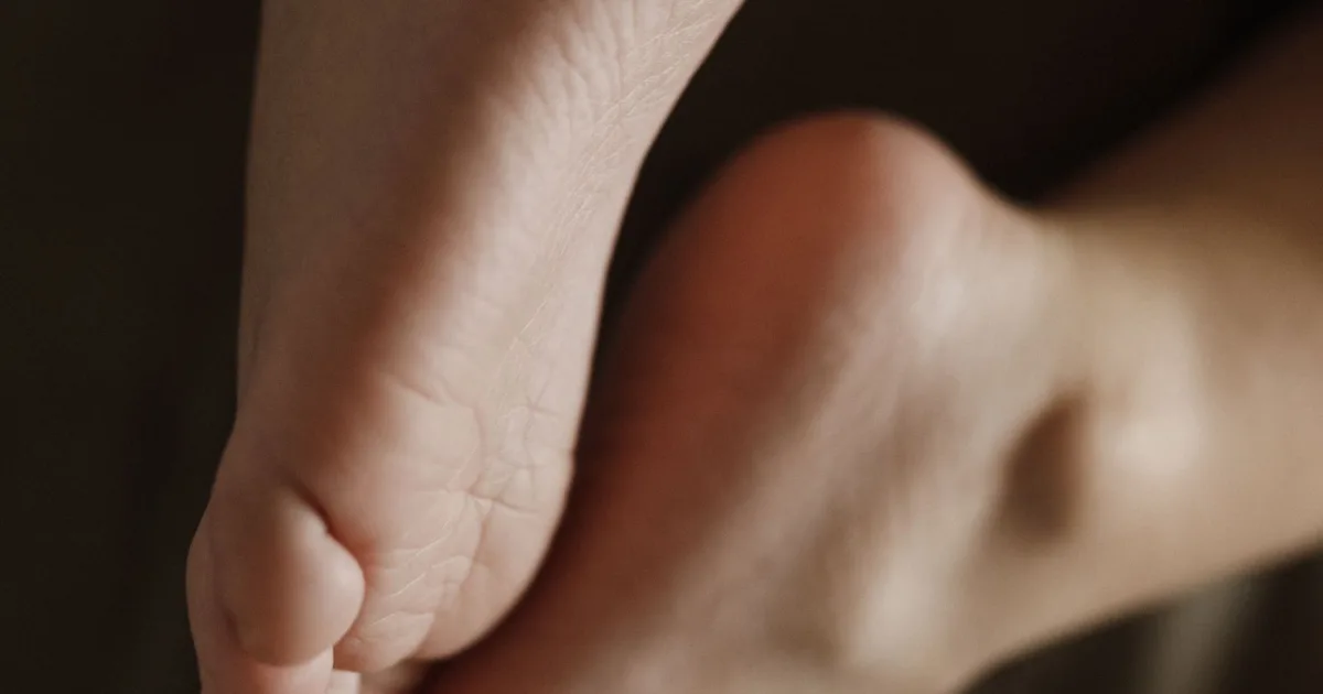 Bare foot rising onto the toes in warm light — best shoes for turf toe, Podiatrist Tested