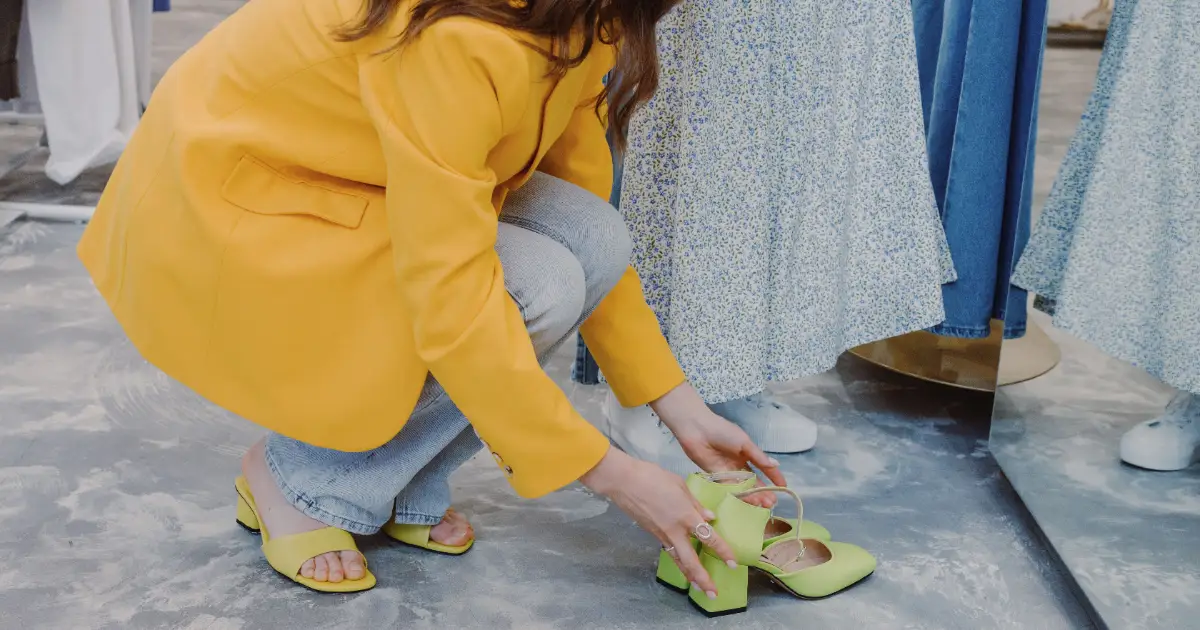 A woman choosing shoes in a store — orthopedic shoes for women, Podiatrist Tested