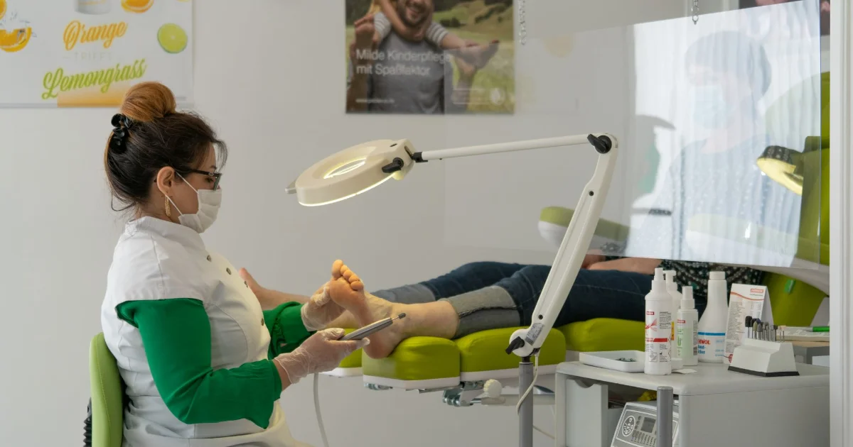 A clinician treating a patient foot in a podiatry clinic - podiatrist recommended shoes, Podiatrist Tested