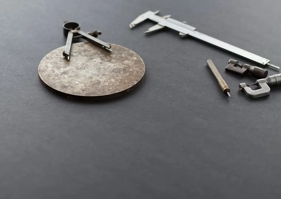 Precision measuring instruments laid out on a dark surface — podiatrist-written shoe guides, Podiatrist Tested