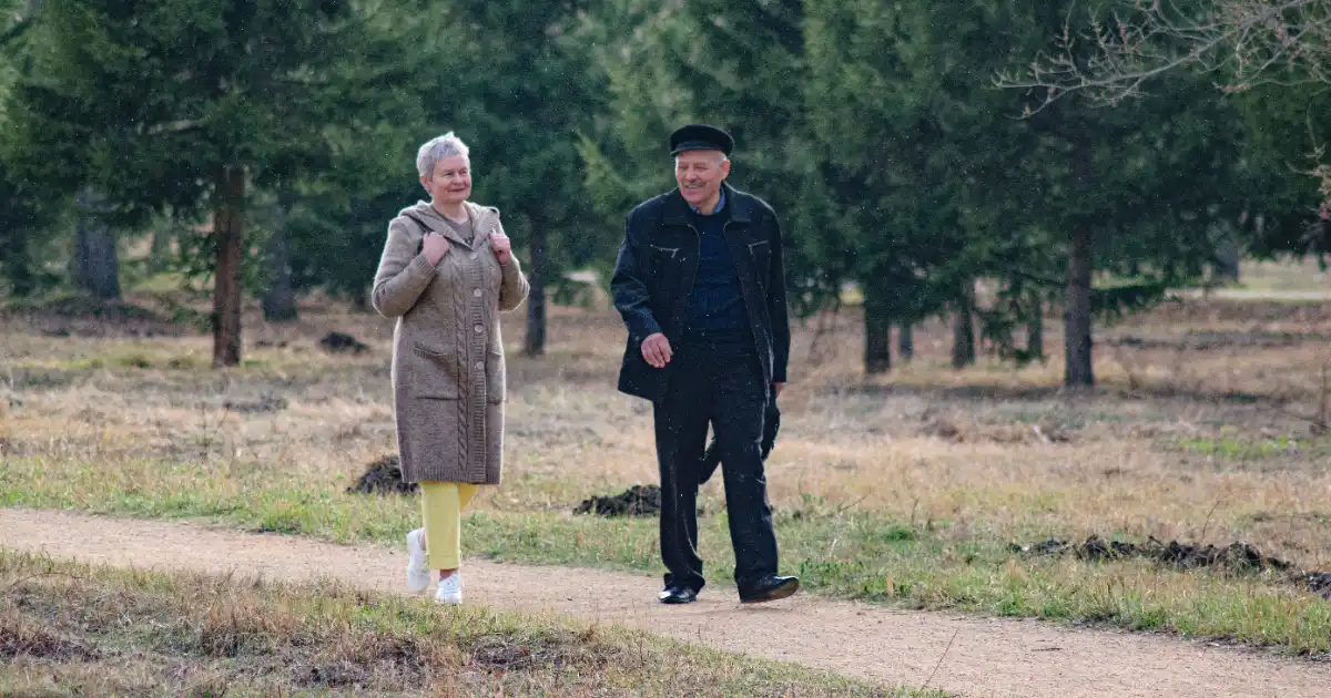 Two people walking a park path in spring — best walking shoes for plantar fasciitis, Podiatrist Tested